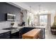 Modern kitchen featuring sleek black cabinetry, stainless steel appliances, and an island overlooking living area at 4925 W 10Th Ave # 111, Denver, CO 80204