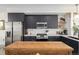 Spacious kitchen with black cabinets, modern appliances, and a large island for food preparation at 4925 W 10Th Ave # 111, Denver, CO 80204