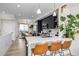 A modern kitchen with white countertop, black cabinets, and a dining area beyond at 4925 W 10Th Ave # 111, Denver, CO 80204