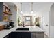 Bright kitchen showcases white quartz countertops and stainless steel dishwasher at 4925 W 10Th Ave # 111, Denver, CO 80204