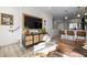 Comfortable living space featuring a media console and seamless flow to the kitchen and dining area at 4925 W 10Th Ave # 111, Denver, CO 80204