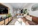 Open-concept living area with modern furnishings flowing into a well-appointed kitchen at 4925 W 10Th Ave # 111, Denver, CO 80204