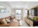 Bright living room featuring a leather couch, ample light, and stylish decor at 4925 W 10Th Ave # 111, Denver, CO 80204