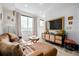 Living room featuring large windows and a comfortable leather couch at 4925 W 10Th Ave # 111, Denver, CO 80204