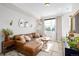Bright living room featuring neutral paint, hard surface floors and a large window at 4925 W 10Th Ave # 111, Denver, CO 80204