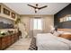 Comfortable primary bedroom with wood accent wall, hardwood floors and a vintage dresser at 4925 W 10Th Ave # 111, Denver, CO 80204