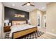 Comfortable primary bedroom features a wood accent wall, and ensuite bathroom at 4925 W 10Th Ave # 111, Denver, CO 80204