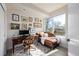 Bright office with a large window, leather chaise lounge, and dark wood desk at 4925 W 10Th Ave # 111, Denver, CO 80204