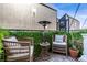 Outdoor patio area with comfortable wicker chairs, a heater, and views of the surrounding landscape at 4925 W 10Th Ave # 111, Denver, CO 80204