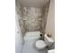 This bathroom features a shower with tile surround, a toilet, and functional shelving at 3225 S Garrison St # 19, Lakewood, CO 80227