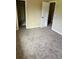 View of bedroom with neutral color palette, new carpet and a closet space at 3225 S Garrison St # 19, Lakewood, CO 80227