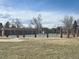 A fenced community pool area with a brick and iron fence, perfect for summer relaxation and recreation at 3225 S Garrison St # 19, Lakewood, CO 80227