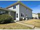 Two-story home with gray siding, brick accents, a well-manicured lawn, and a walkway leading to the front door at 3225 S Garrison St # 19, Lakewood, CO 80227