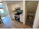 The kitchen leads to storage under stairs with light wood-look floors at 3225 S Garrison St # 19, Lakewood, CO 80227