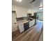 Updated kitchen with white cabinets and stainless steel appliances at 3225 S Garrison St # 19, Lakewood, CO 80227