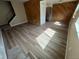Open-concept living room with wood paneling and wood-look flooring at 3225 S Garrison St # 19, Lakewood, CO 80227