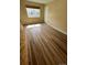 Bright living room featuring wood-look floors and a large window at 3225 S Garrison St # 19, Lakewood, CO 80227
