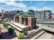 Expansive aerial view of a building showcasing its design, location, and urban surroundings on a clear, sunny day at 1735 19Th St # 6D, Denver, CO 80202