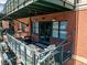 Inviting balcony with brick, outdoor seating, and ambient string lights for a cozy and relaxing outdoor space at 1735 19Th St # 6D, Denver, CO 80202