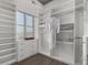 Walk-in closet with custom shelving, drawers, and natural light from the window at 1735 19Th St # 6D, Denver, CO 80202