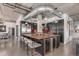 Modern open concept kitchen featuring dark cabinetry, stainless appliances, and industrial-style lighting at 1735 19Th St # 6D, Denver, CO 80202