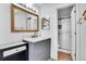 Stylish bathroom featuring a marble countertop, modern fixtures, and a tiled shower with glass door at 7891 Allison Way # 201, Arvada, CO 80005