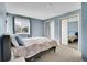 Cozy bedroom with a large window, plush carpeting, and ample closet space with sliding mirror doors at 7891 Allison Way # 201, Arvada, CO 80005