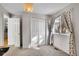 Bright bedroom with large window and closet, showcasing natural light and neutral tones at 7891 Allison Way # 201, Arvada, CO 80005