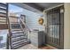 Welcoming condo entrance with a secure door, staircase, and decorative touches at 7891 Allison Way # 201, Arvada, CO 80005