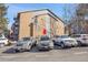 A brick exterior of a multi-story building with parking for residents at 7891 Allison Way # 201, Arvada, CO 80005