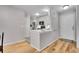 An open concept kitchen with white cabinets and stainless steel appliances at 7891 Allison Way # 201, Arvada, CO 80005