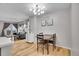 Open living room area featuring hardwood floors, modern lighting, and comfortable furniture at 7891 Allison Way # 201, Arvada, CO 80005