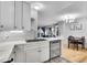 Open kitchen and living room with hardwood floors, modern lighting, and stainless steel appliances at 7891 Allison Way # 201, Arvada, CO 80005