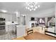 Bright living room featuring a fireplace, eat in kitchen, hardwood floors, and a modern light fixture at 7891 Allison Way # 201, Arvada, CO 80005