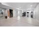 Large, open basement area features a workout zone and access to a bathroom, offering flexibility and functionality at 317 Bonanza Dr, Erie, CO 80516