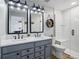 Modern bathroom boasts dual sinks, stylish fixtures, and a glass-enclosed shower at 317 Bonanza Dr, Erie, CO 80516
