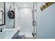 Modern bathroom featuring a glass shower with a bench, and sleek fixtures at 317 Bonanza Dr, Erie, CO 80516