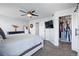 Bright bedroom featuring a closet, ceiling fan, and TV at 317 Bonanza Dr, Erie, CO 80516
