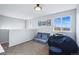Bright bedroom featuring a cozy beanbag chair and a large window with natural light at 317 Bonanza Dr, Erie, CO 80516