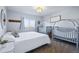Bright bedroom features a king bed and two gray cribs, creating a functional and cozy space for a growing Gathering at 317 Bonanza Dr, Erie, CO 80516