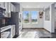 Modern kitchen showcasing stainless steel appliances, white cabinets, and scenic backyard views at 317 Bonanza Dr, Erie, CO 80516