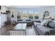Spacious living room features a large sectional sofa, expansive windows, and stylish decor at 317 Bonanza Dr, Erie, CO 80516