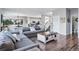 Inviting living room featuring an open layout, seamlessly connecting to the dining area and kitchen at 317 Bonanza Dr, Erie, CO 80516