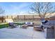 Outdoor patio featuring comfortable seating, a grill, and privacy fencing, creating an ideal space for entertaining or relaxing at 317 Bonanza Dr, Erie, CO 80516