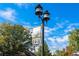 Downtown Erie sign on a vintage street lamp surrounded by mature trees and clear blue skies at 317 Bonanza Dr, Erie, CO 80516