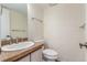 Bathroom with sink, vanity, toilet, and granite countertop at 1030 Jersey St # 1, Denver, CO 80220