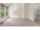 Bedroom with neutral carpet, large windows, and bathroom access at 1030 Jersey St # 1, Denver, CO 80220