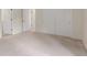 Bright bedroom featuring neutral carpet, closet, and multiple doors at 1030 Jersey St # 1, Denver, CO 80220