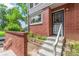 The home's entrance boasts charming brick accents and a well-maintained walkway at 1030 Jersey St # 1, Denver, CO 80220