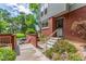 Townhome boasting a cozy patio and landscaped front yard, offering curb appeal at 1030 Jersey St # 1, Denver, CO 80220